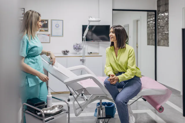 A woman talking with her doctor in a medical office.