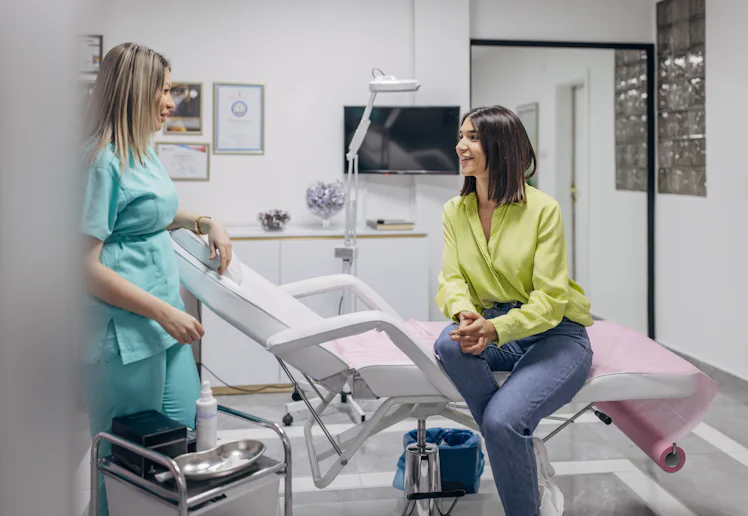 A woman talking with her doctor in a medical office.
