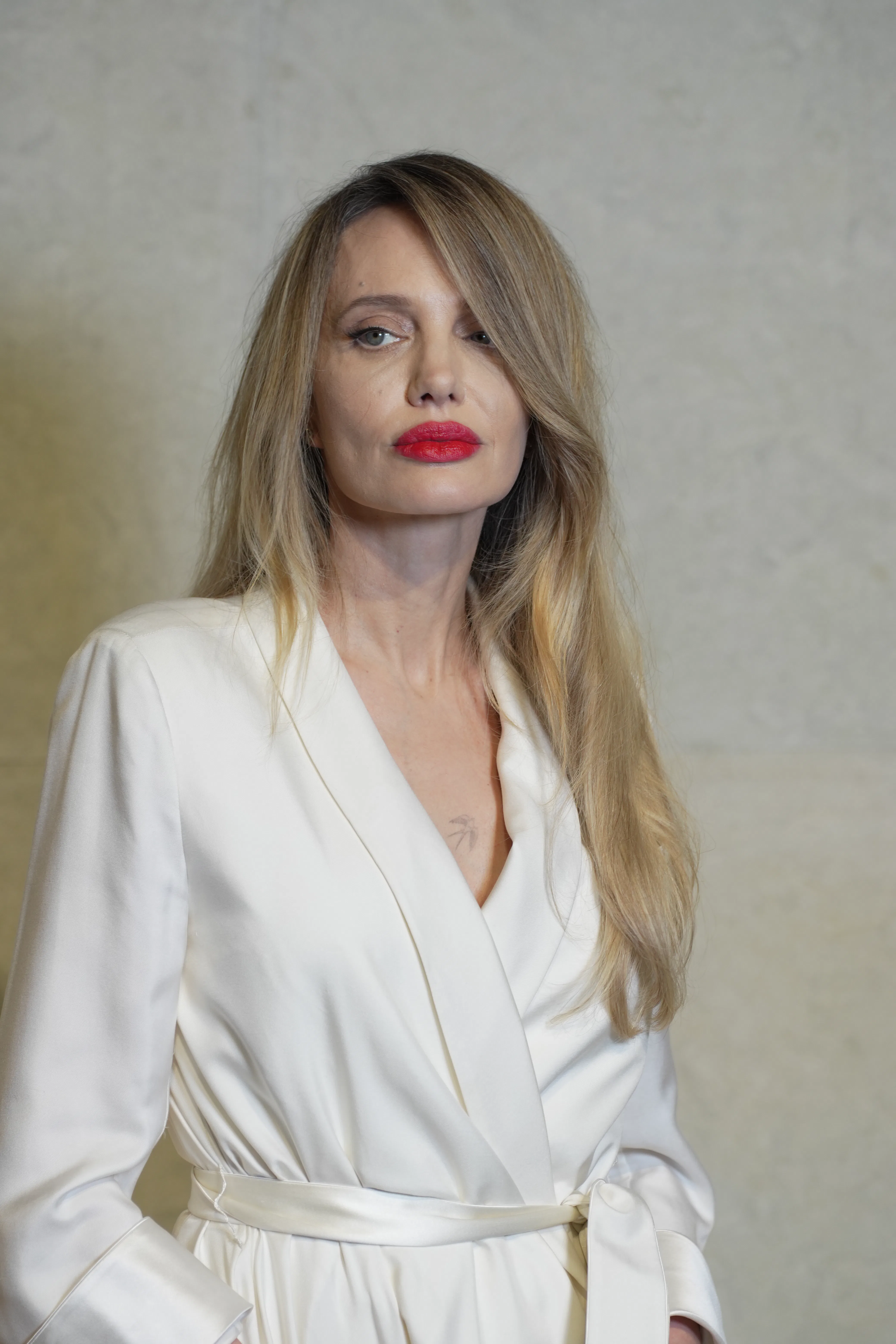 Angelina Jolie Styles Robe Coat With Bold Red Lip and Side Part Hair