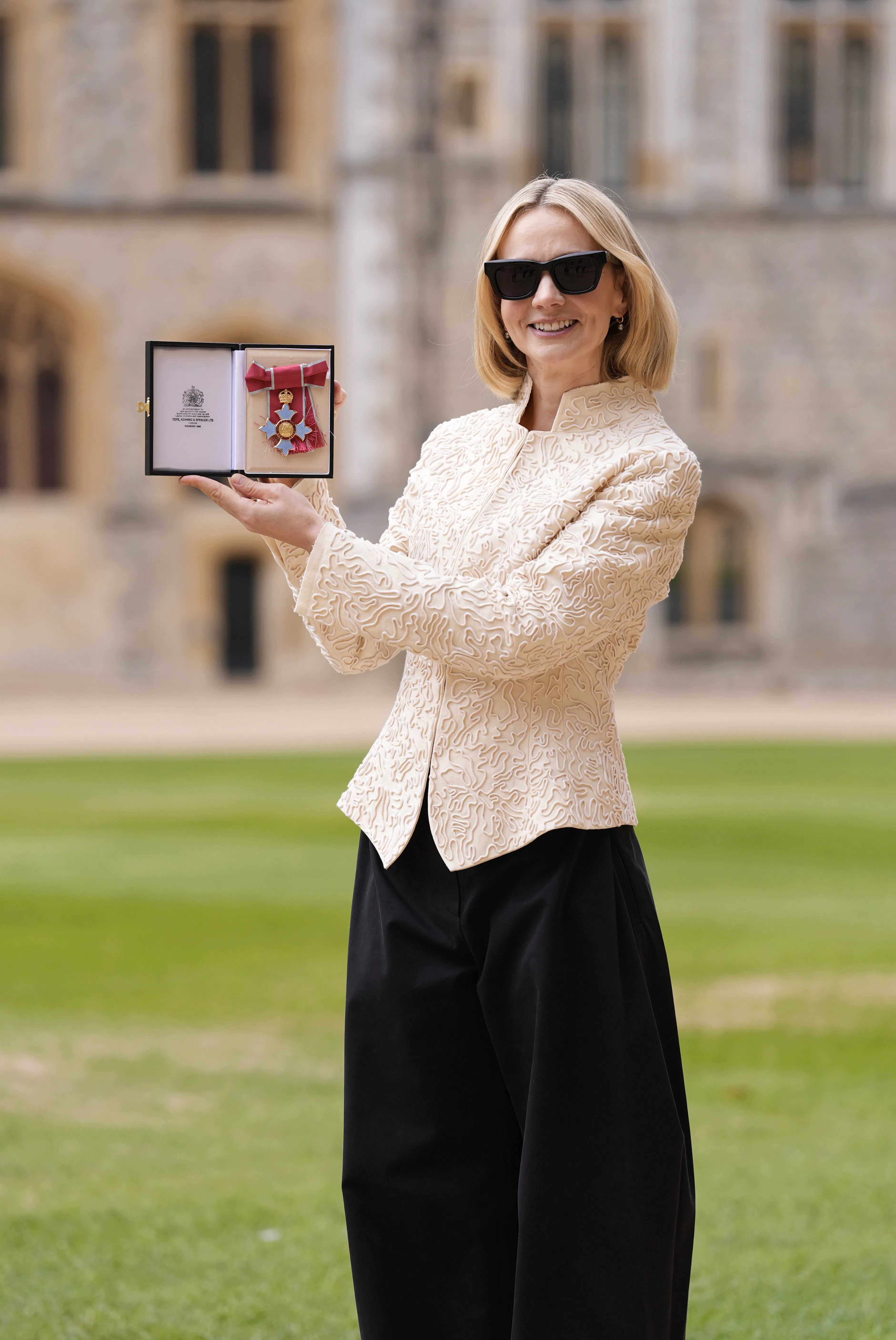 Actress Carey Mulligan poses after being made a Commander of the Order of the British Empire (CBE) a...