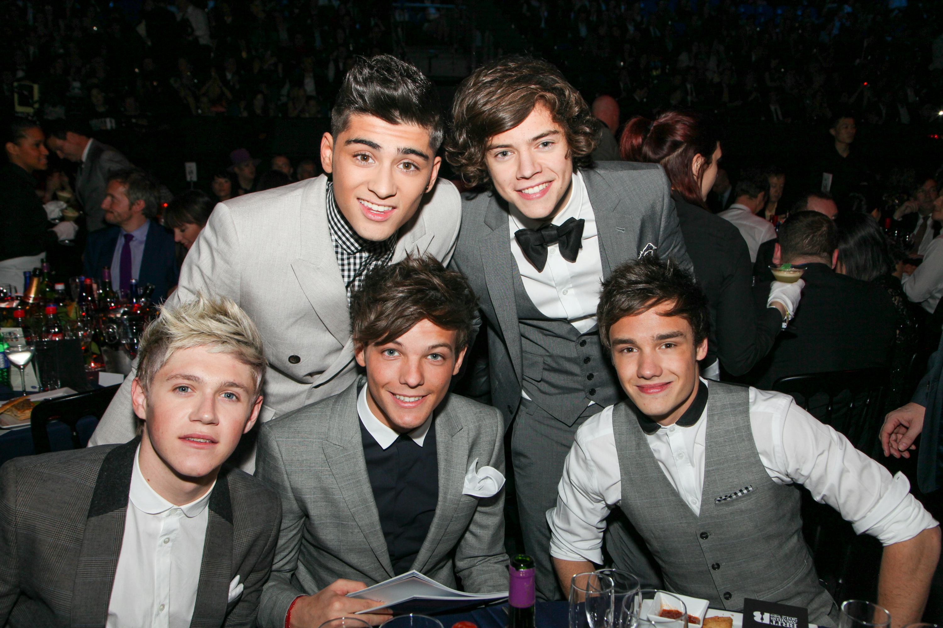 One Direction pose at tables during The BRIT Awards 2012