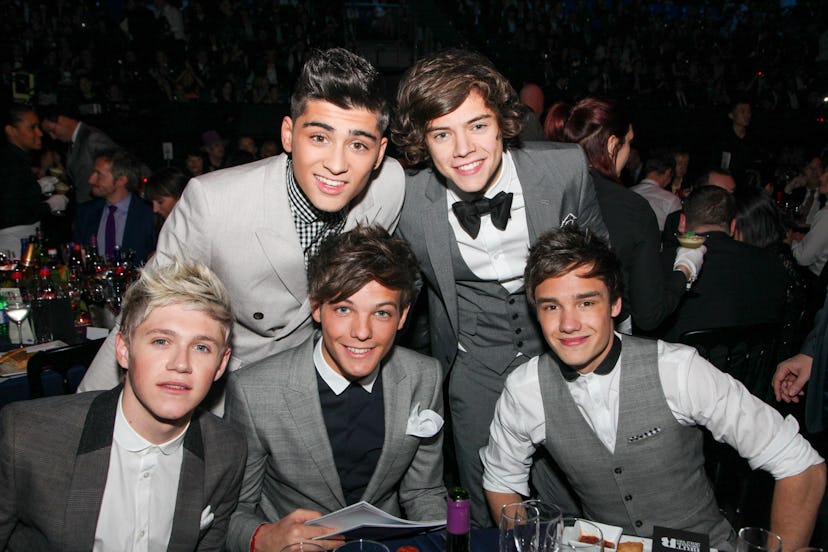 One Direction pose at tables during The BRIT Awards 2012