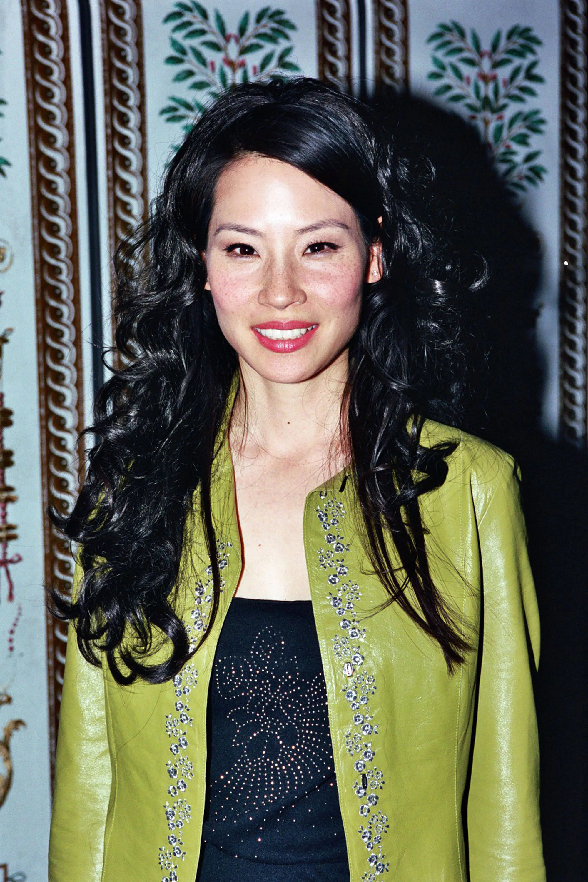 Lucy Liu with curls, bangs, and a deep side part