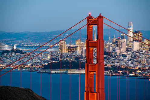 The Golden Gate Bridge and the San Francisco skyline at twilight.