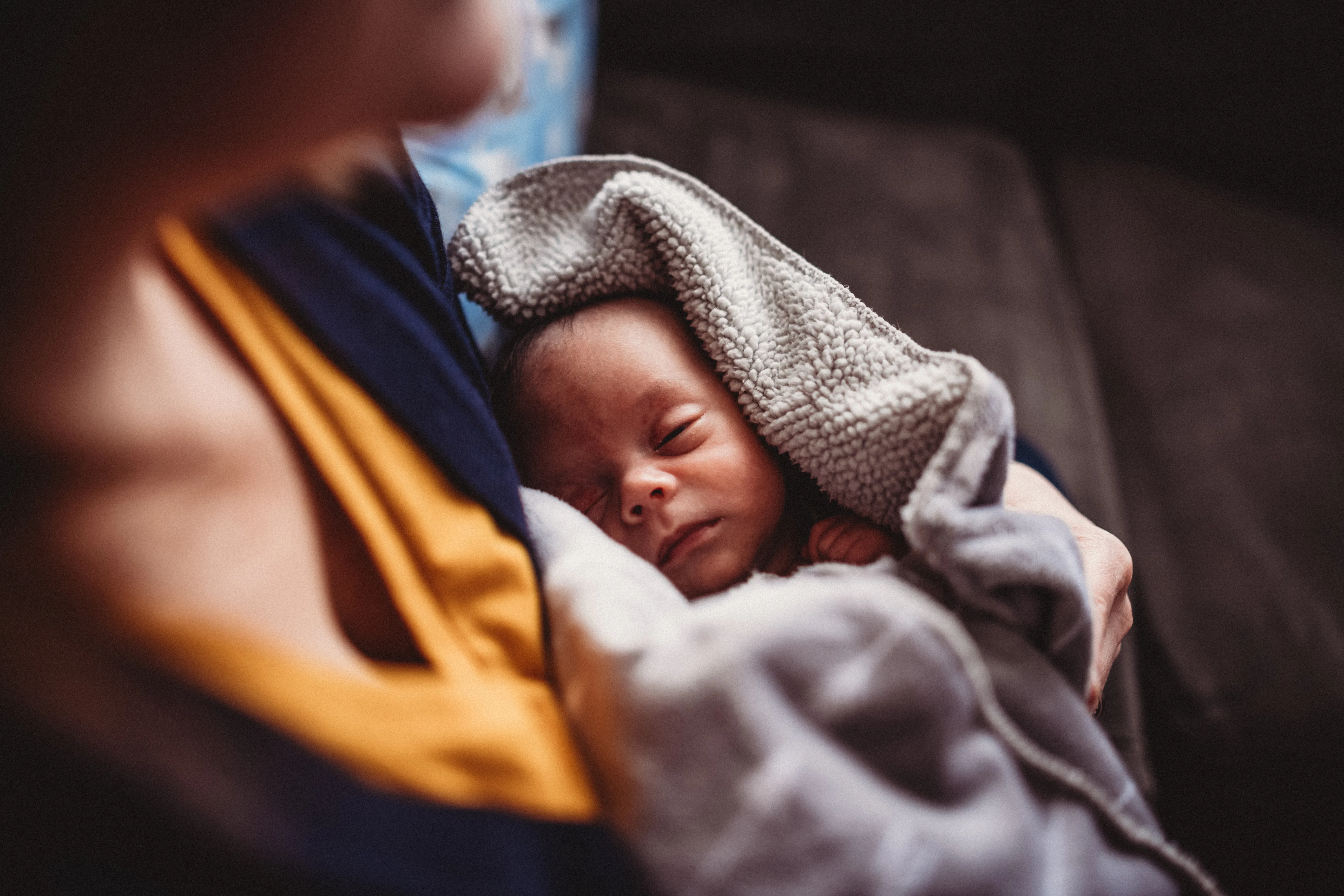 Male newborn (one month) sleeps soundly in his pajamas at home.