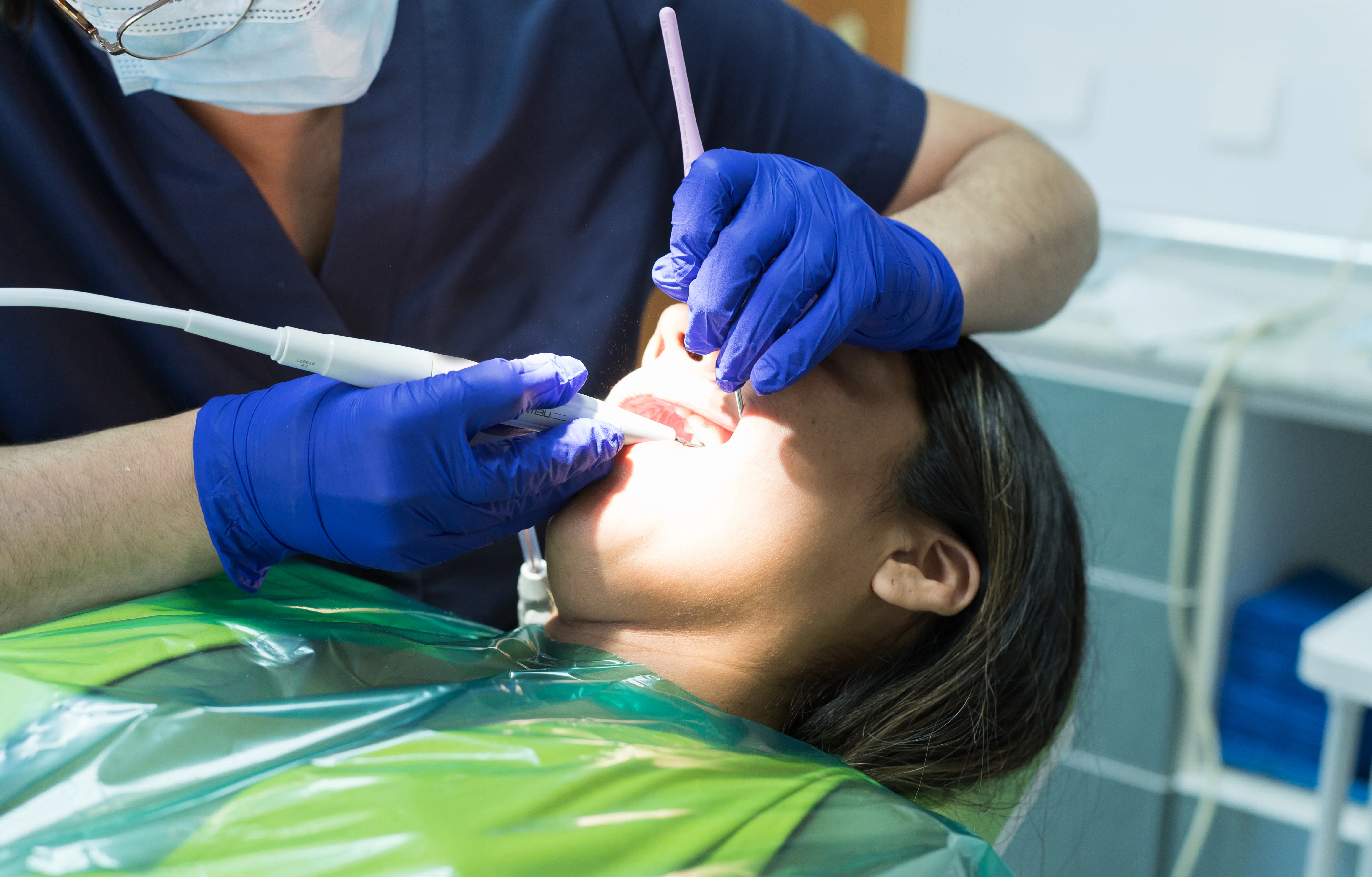 Oral health concepts. Dental Patient Getting Examined by Dentist. Close up of a female dental patien...
