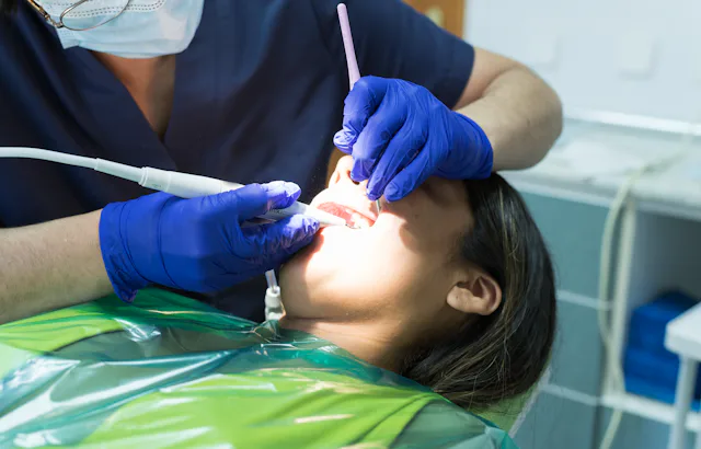 Oral health concepts. Dental Patient Getting Examined by Dentist. Close up of a female dental patien...