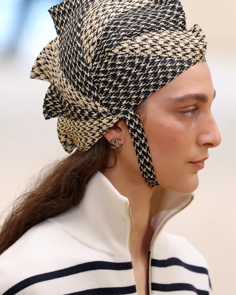 A model, hat detail, walks the runway during the Chanel Cruise 2026/27
