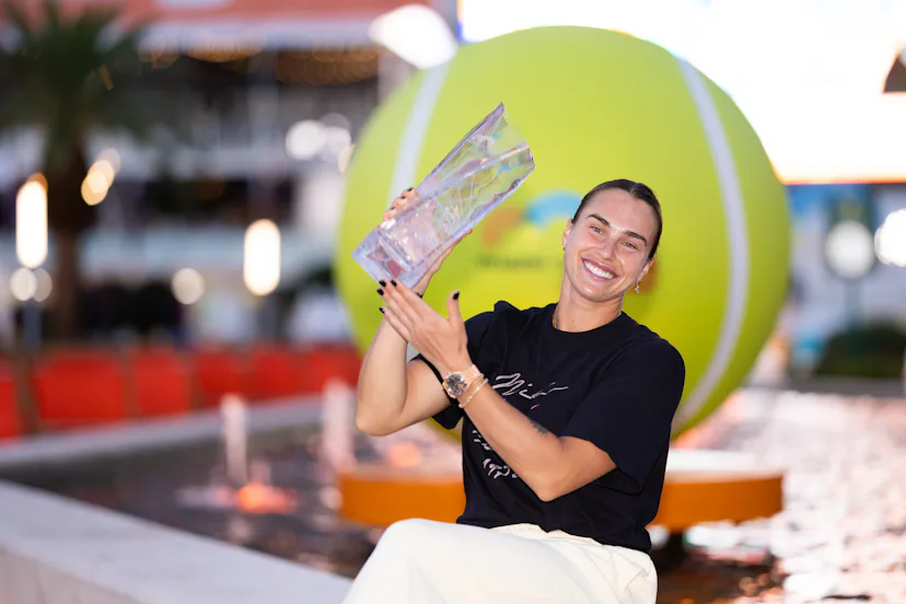 Aryna Sabalenka holds the Butch Buchholz championship trophy.