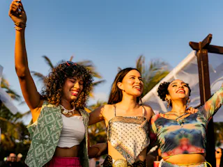 Young friends women dancing during party outdoors