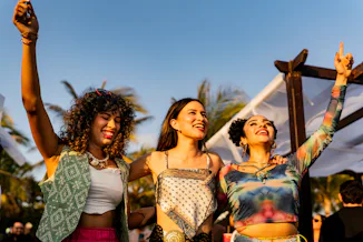 Young friends women dancing during party outdoors