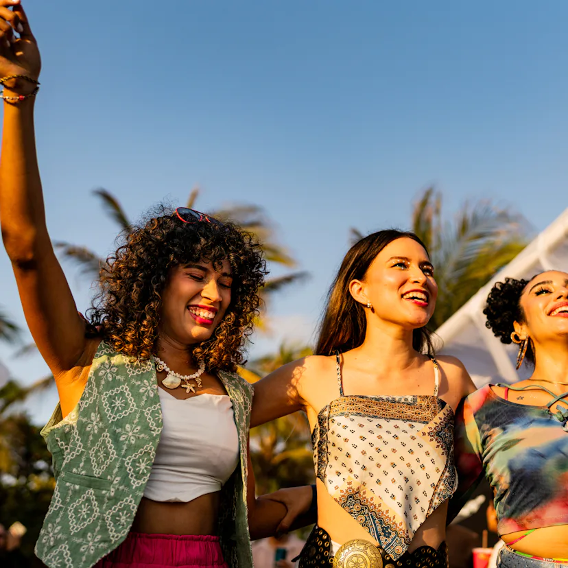 Young friends women dancing during party outdoors