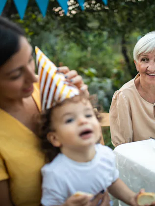 Grandmother and her offspring on birthday party at backyard