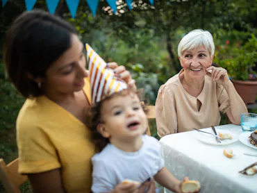 Grandmother and her offspring on birthday party at backyard