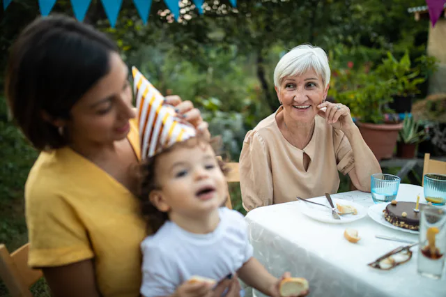 Grandmother and her offspring on birthday party at backyard