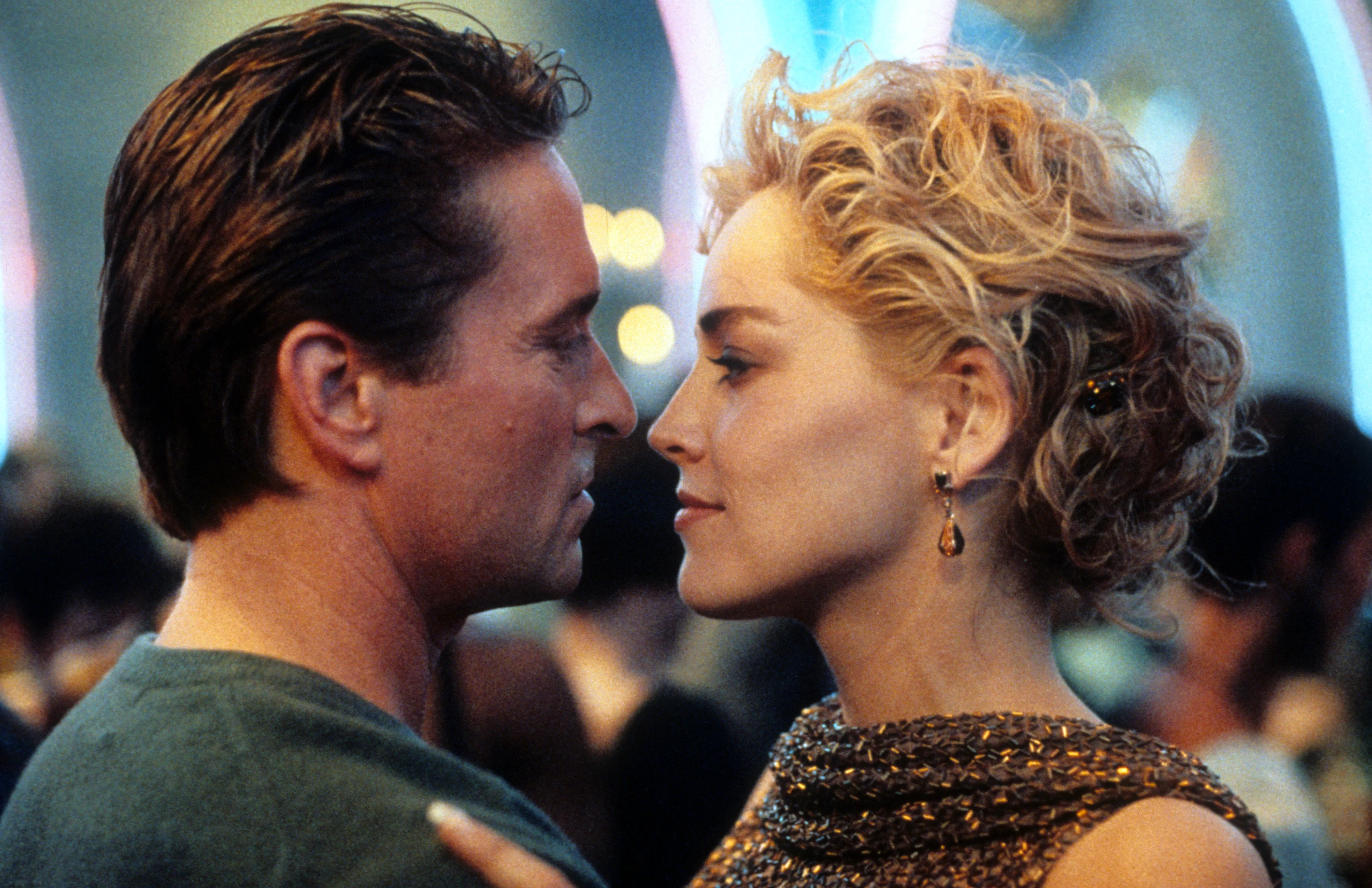 Michael Douglas and Sharon Stone dancing in scene from the film 'Basic Instinct', 1992. (Photo by Tr...