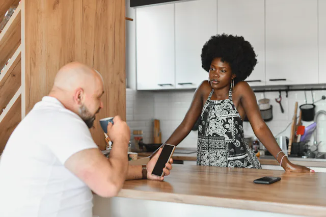 Beautiful Female Looking Angry Talking to Boyfriend and He's Looking at His Phone Ignoring Her