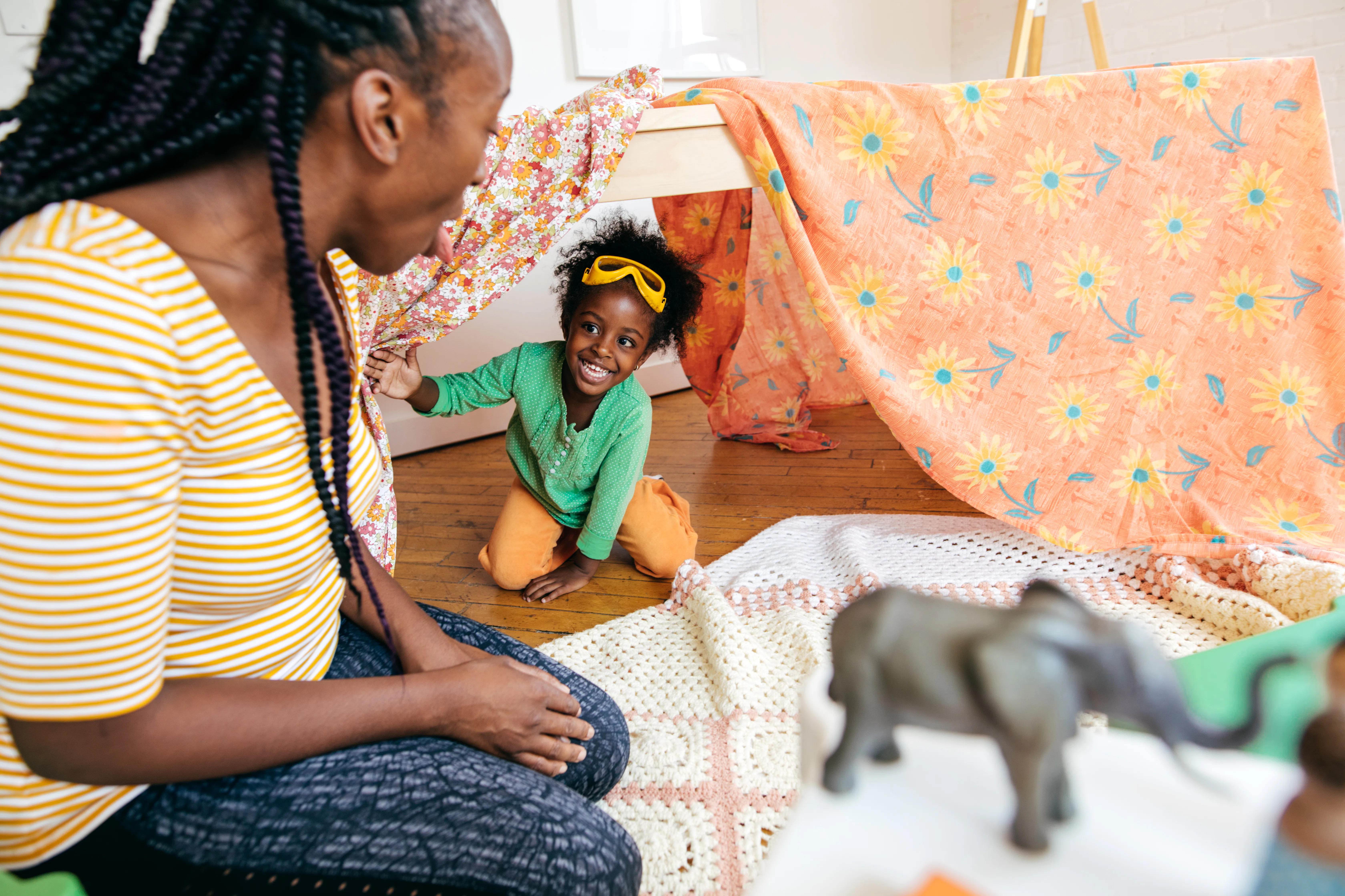 Mother and daughter playing hide and seek