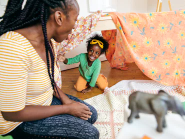 Mother and daughter playing hide and seek