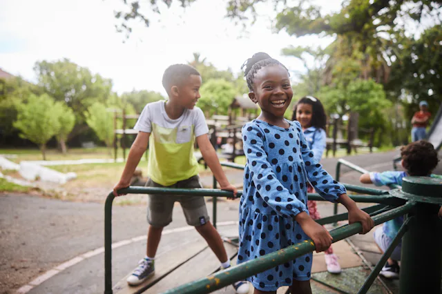 The AAP released new guidelines on recess. Photo shows a little girl playing on a playground with cl...