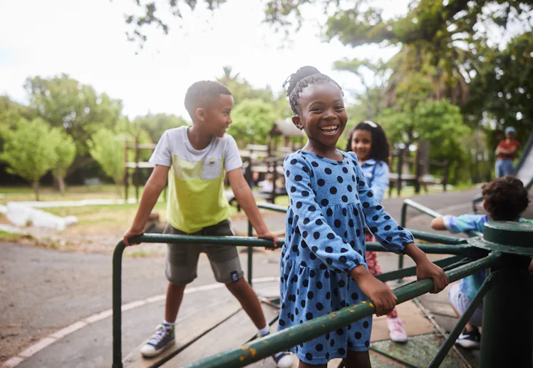 The AAP released new guidelines on recess. Photo shows a little girl playing on a playground with cl...