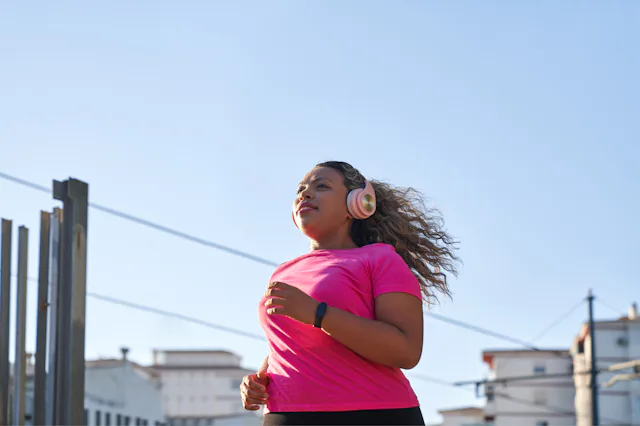 Side view of latin woman with large build running in city