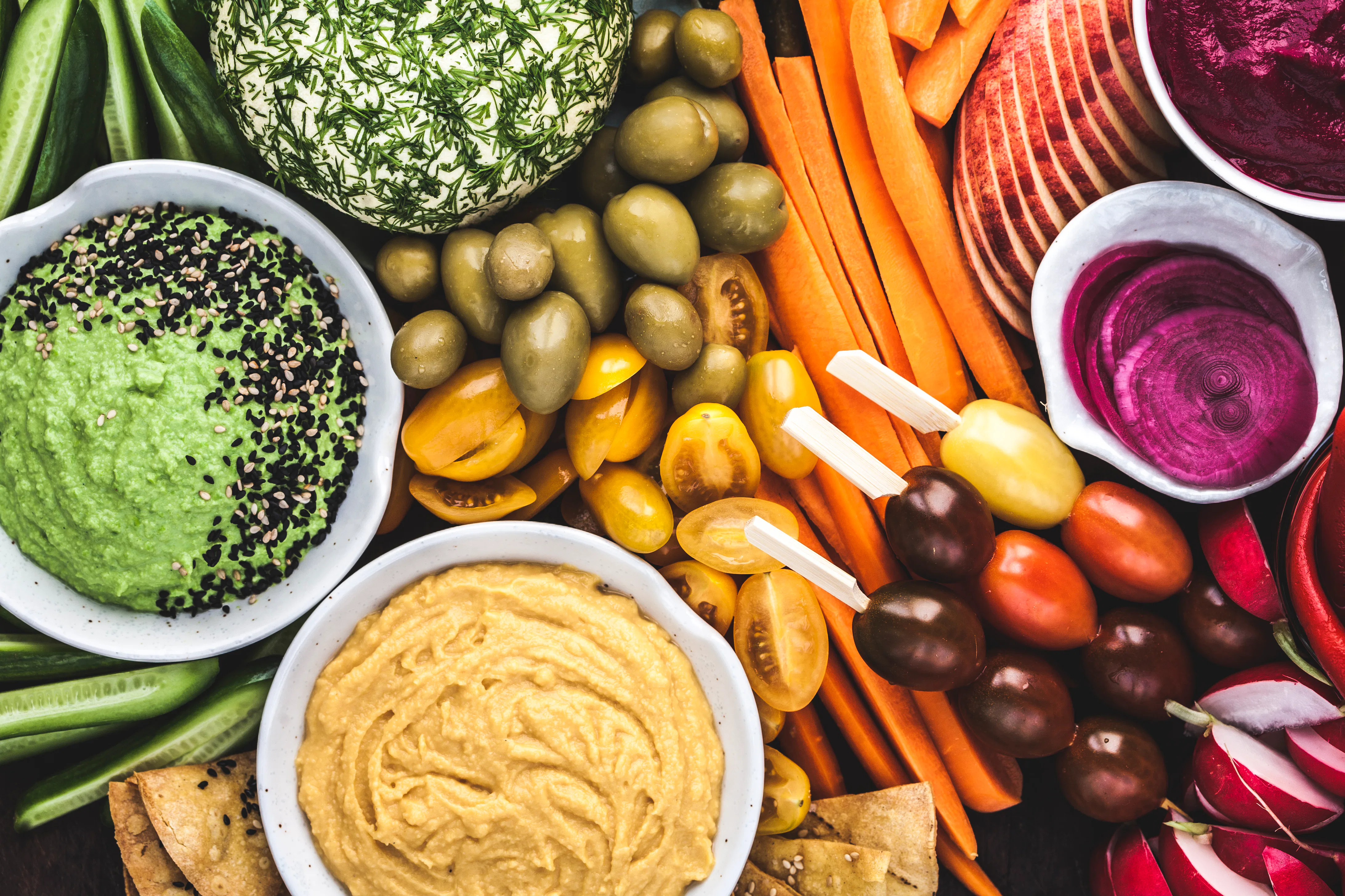 A wonderfully colourful selection of fruits, vegetables, cheese, dips and pickles. All plant based, ...