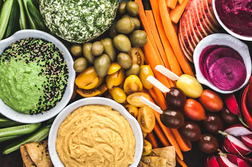 A wonderfully colourful selection of fruits, vegetables, cheese, dips and pickles. All plant based, ...