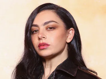 Charli XCX at a Saint Laurent show with pretty diffused makeup