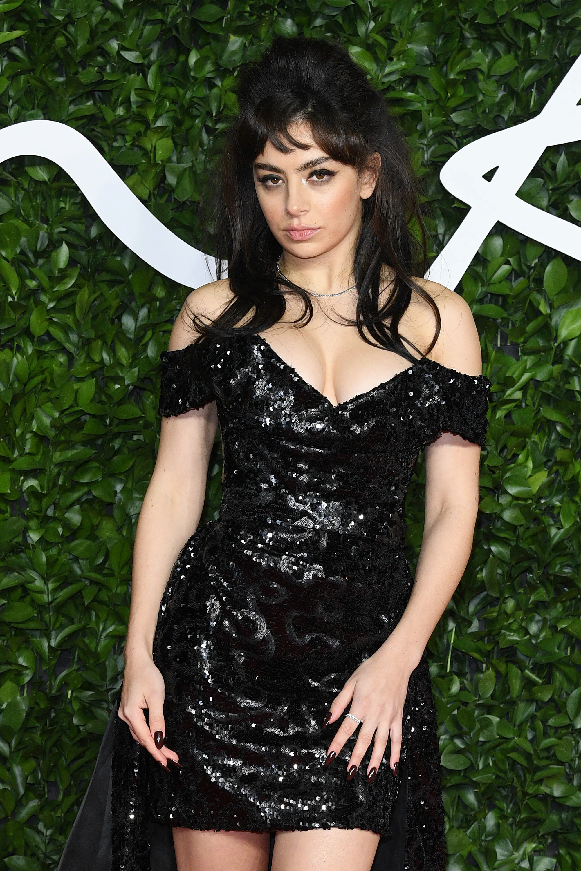 Charli XCX with big hair and dramatic winged eyeliner