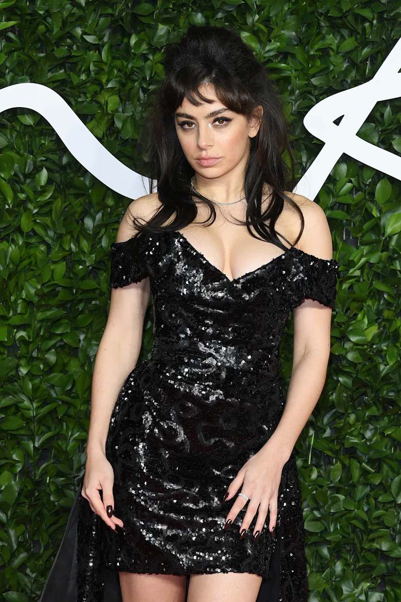 Charli XCX with big hair and dramatic winged eyeliner