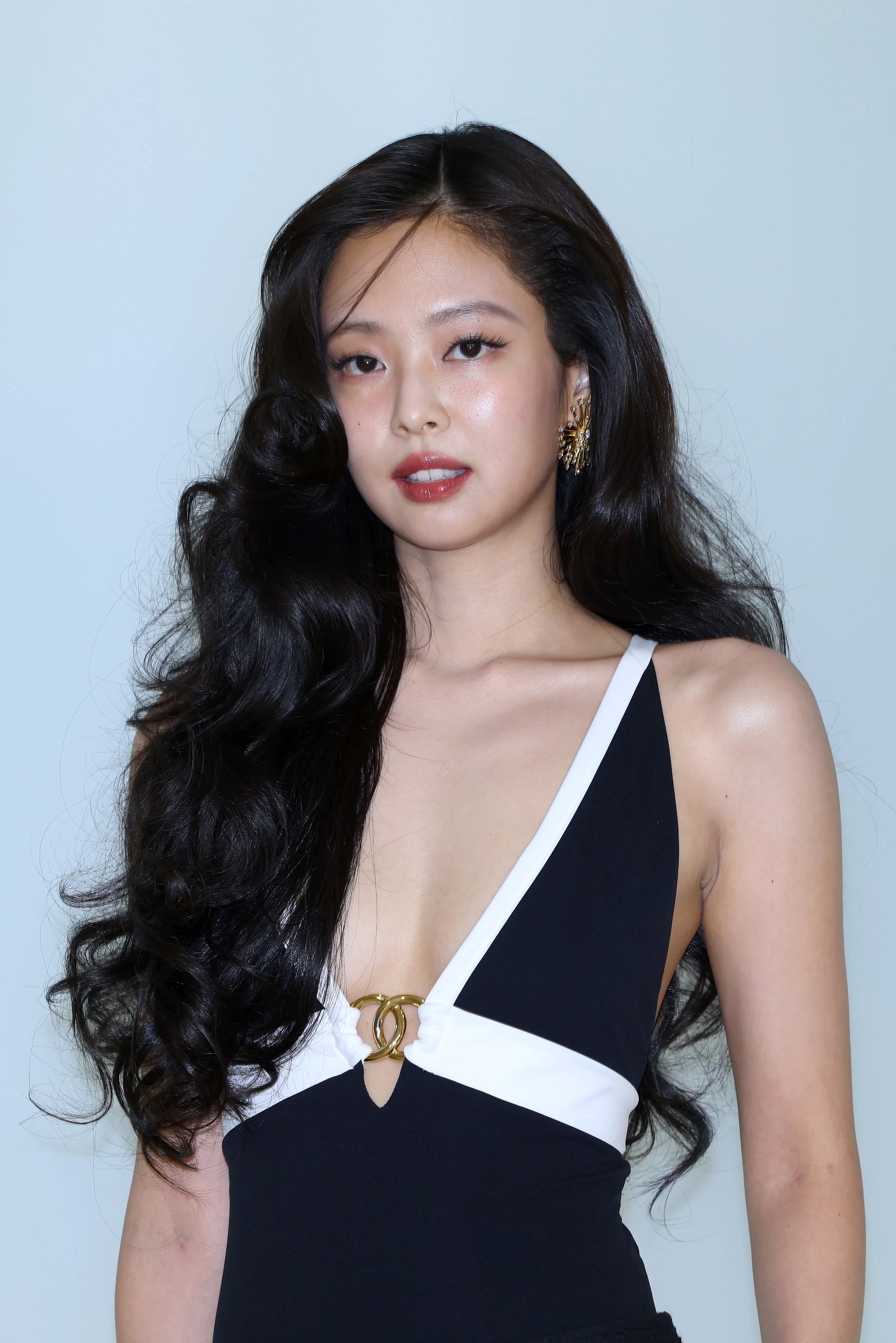 Jennie at the Chanel show in Seoul, standing against a wall