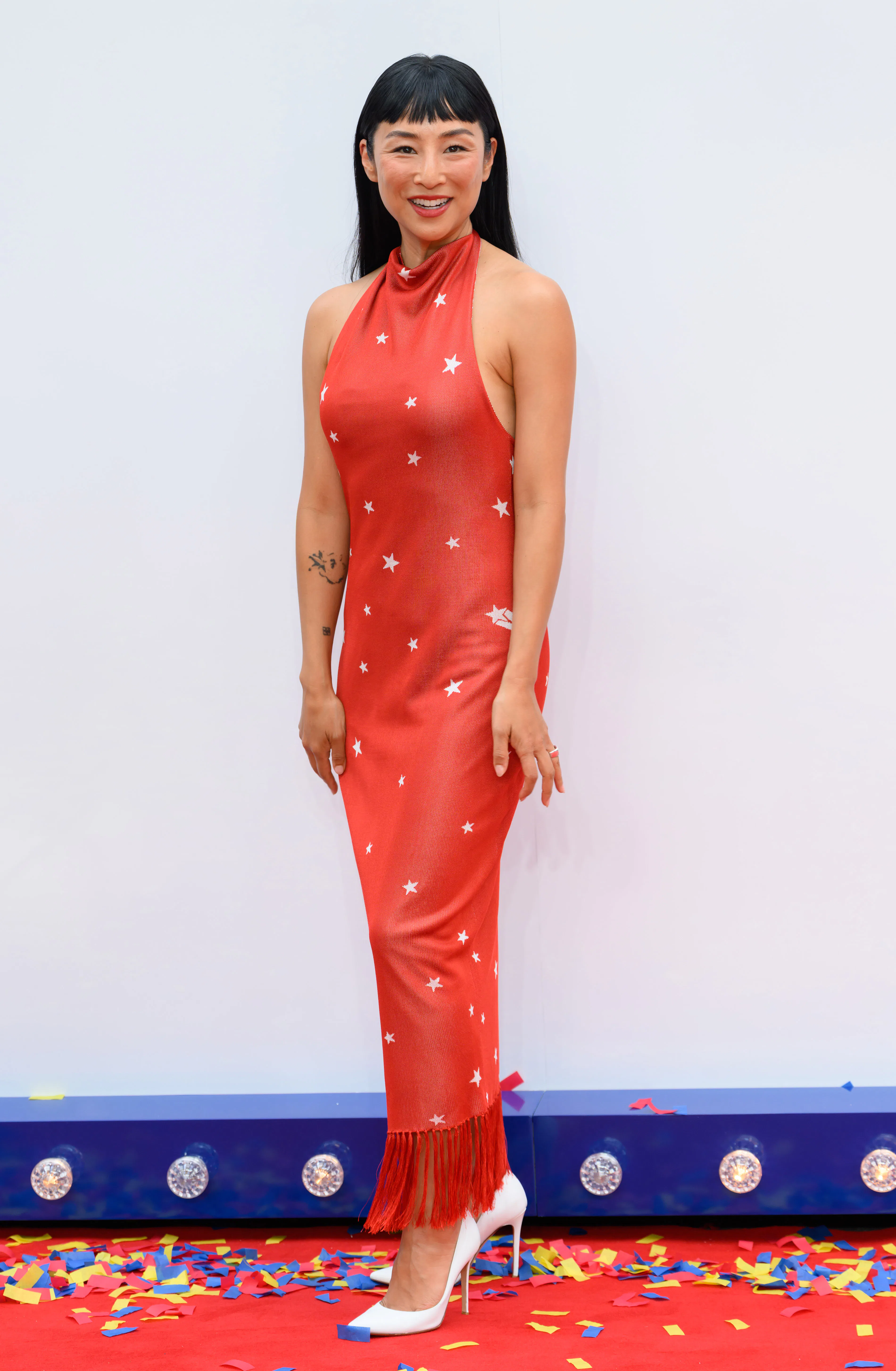 greta lee red dress Leave it to Greta Lee to always have fun with her fashion on the red  carpet. Working with longtime stylist @daniellegoldberg, she was perfectly  on theme in a stretchy red, halter neck dress by