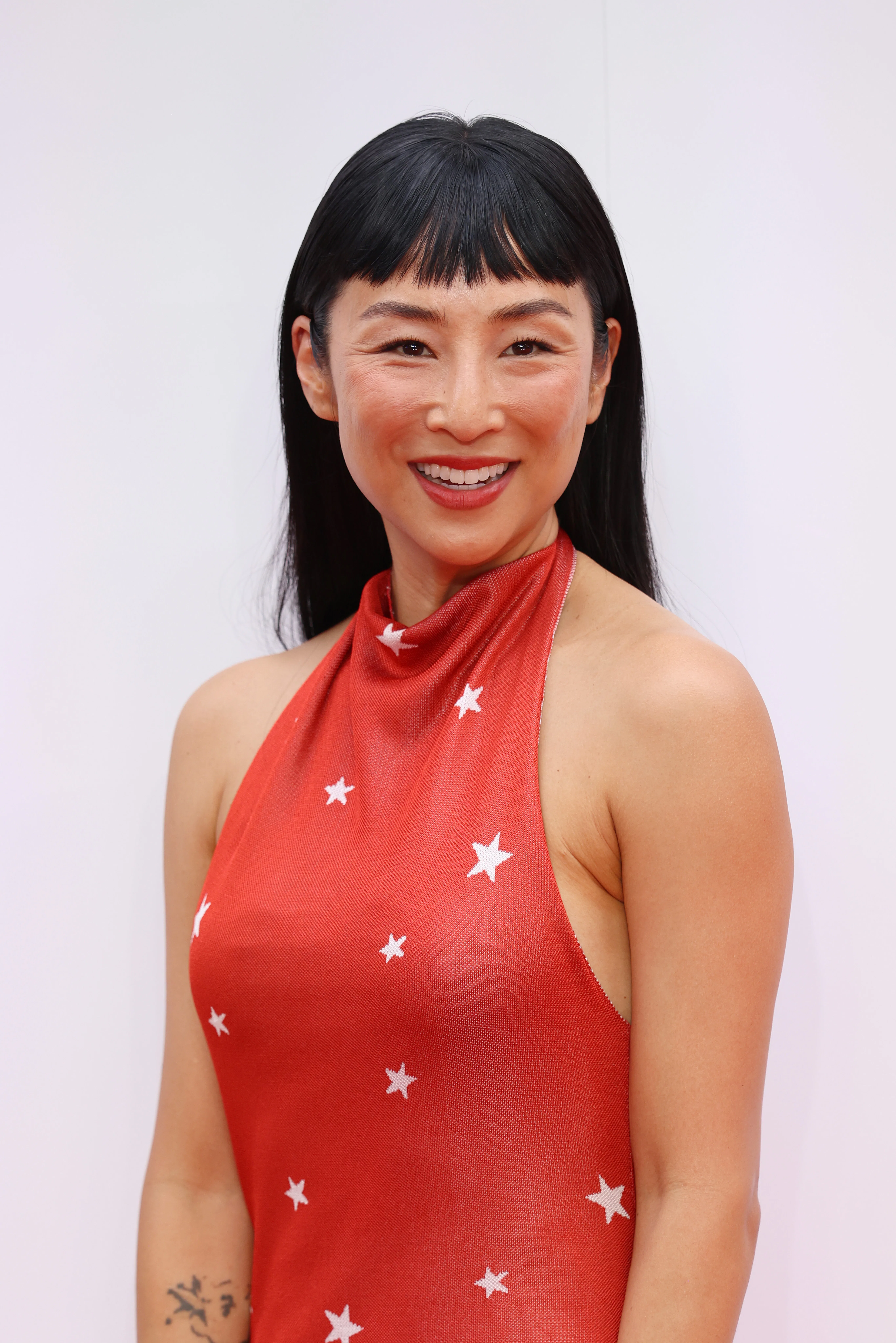 Greta Lee at the Toy Story 5 event with micro bangs