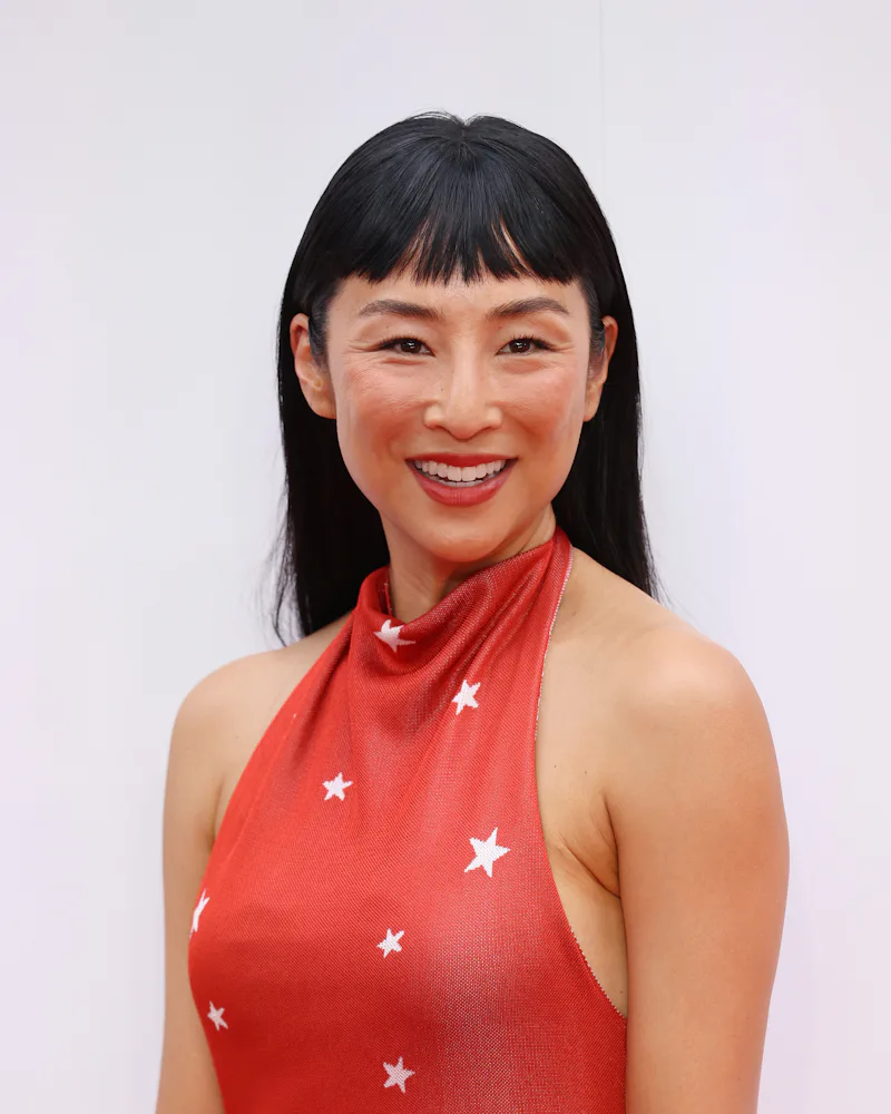 Greta Lee at the Toy Story 5 event with micro bangs