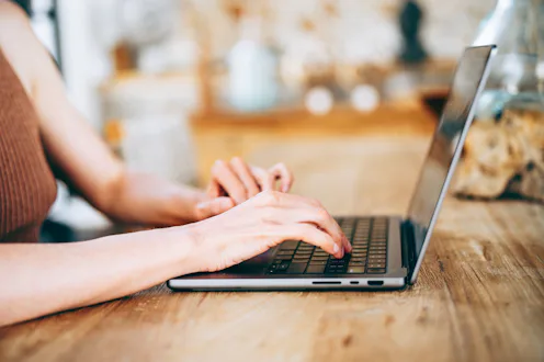woman typing on laptop