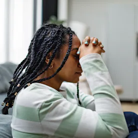 Young black adult woman in depression at home