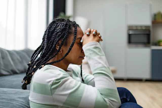Young black adult woman in depression at home