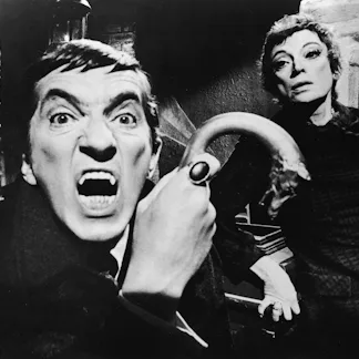 Publicity portrait of Canadian actor Jonathon Frid, a metal-tipped cane in his hand as he bares his ...
