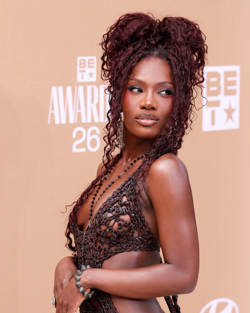 Doechii at the BET Awards 2026 with a curly updo hairstyle with locs at the base