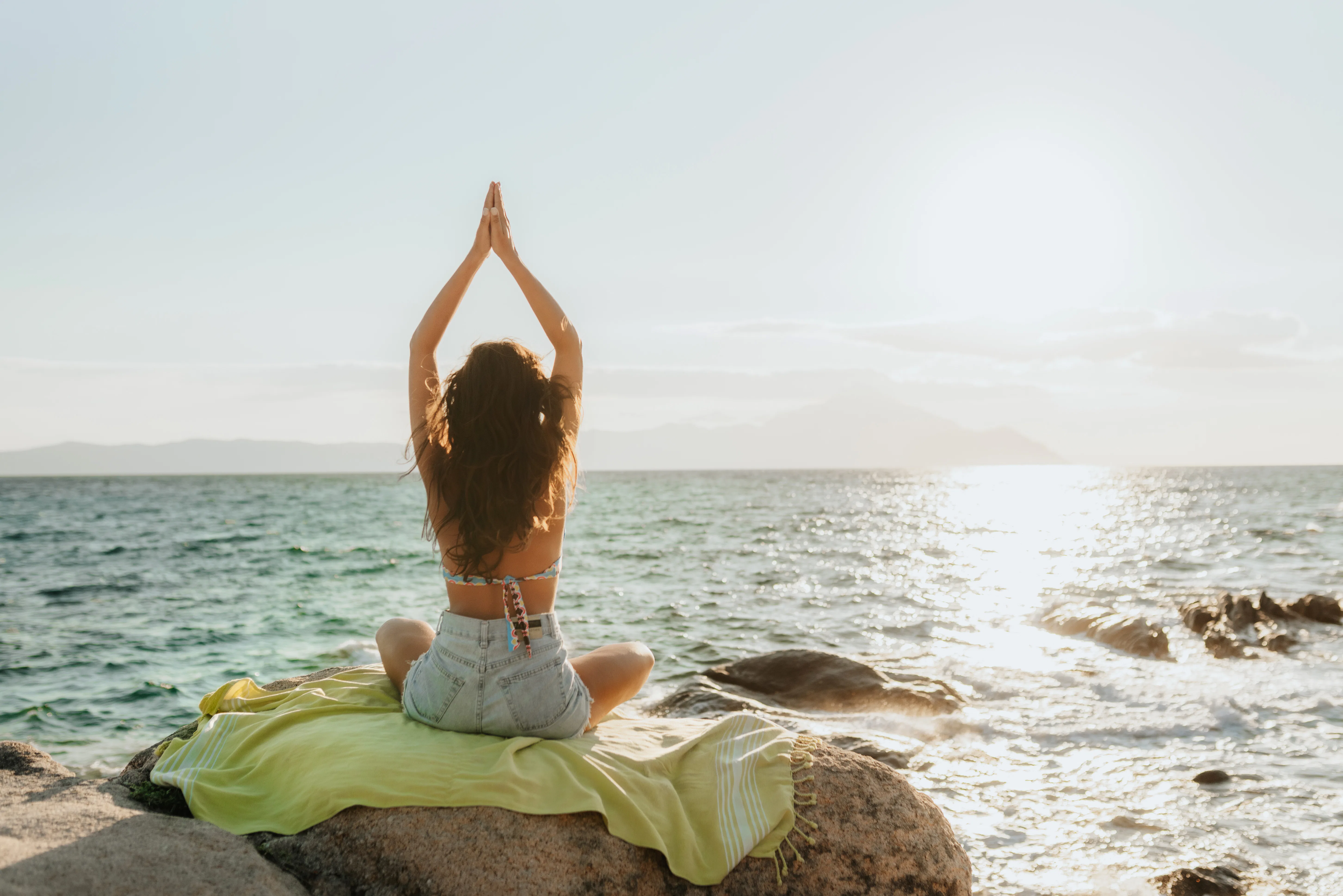 Young woman enjoying a quiet morning by the sea