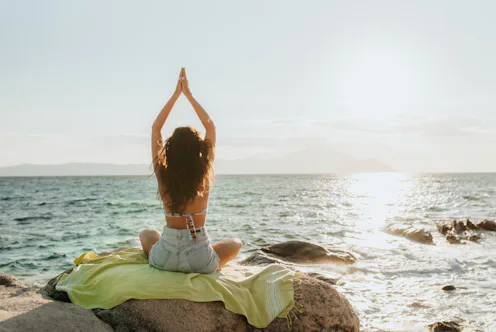 Young woman enjoying a quiet morning by the sea