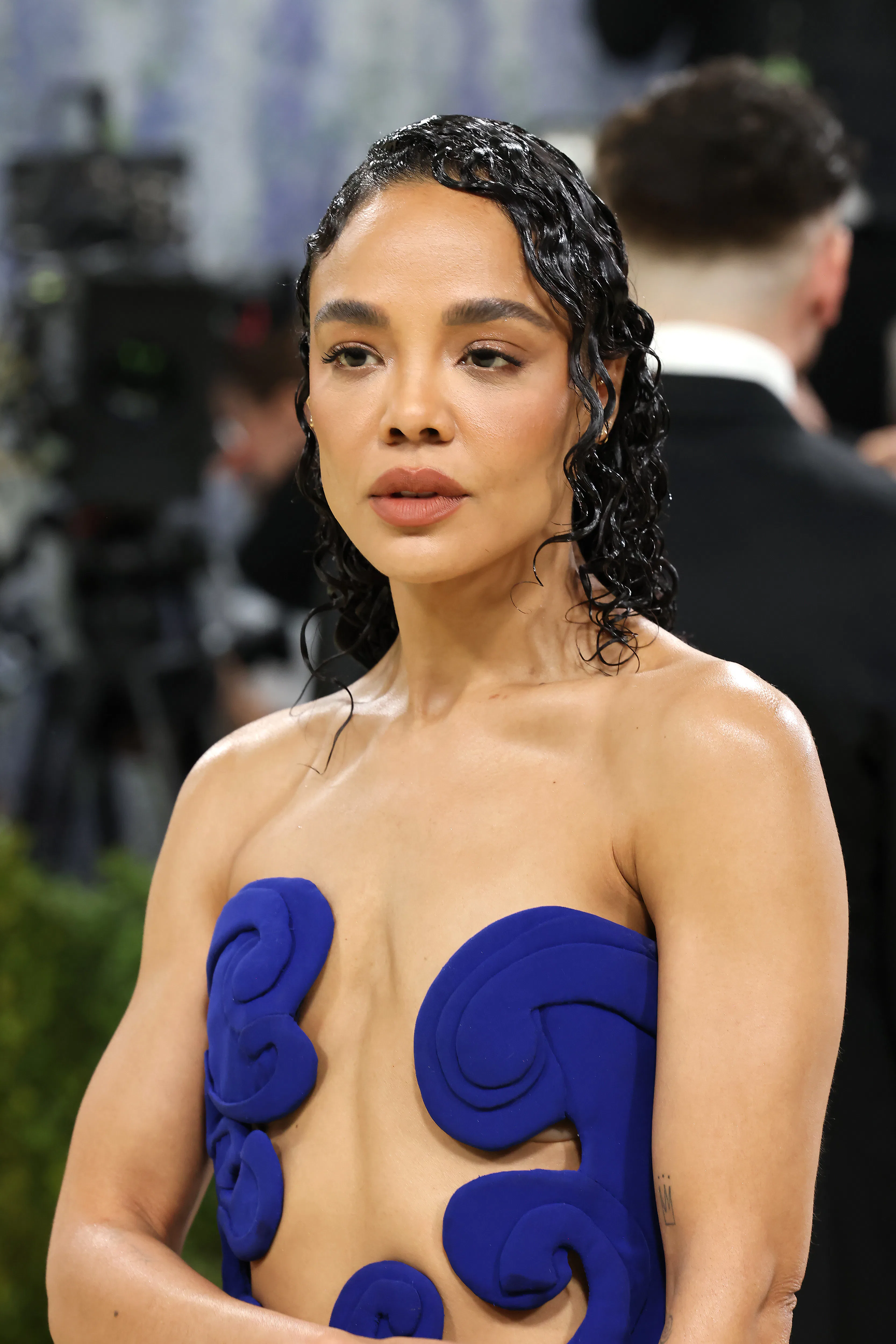 Tessa Thompson with wet-looking sculpted curls at the 2026 Met Gala