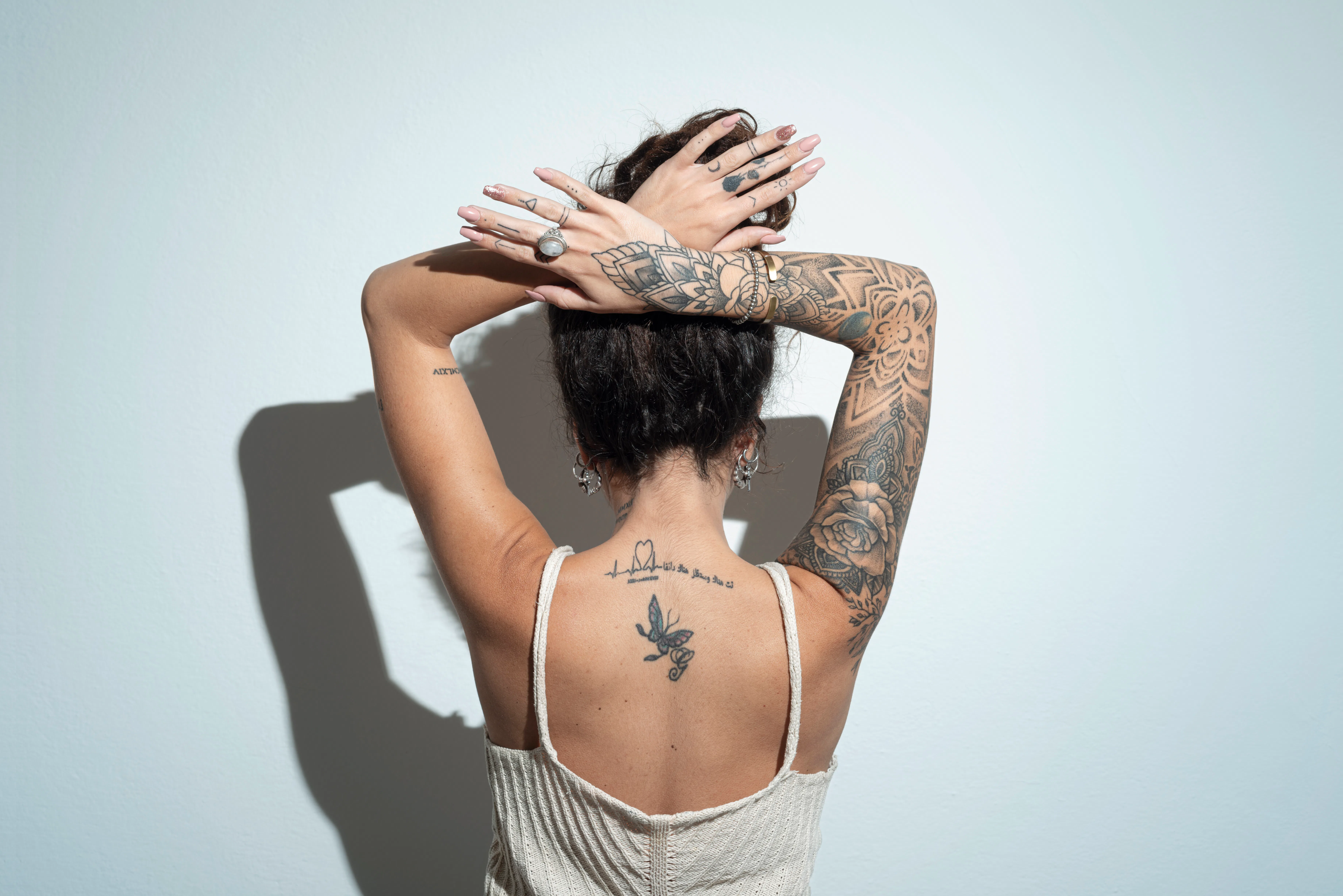 Rear view of a young woman with tattoo.Studio shot