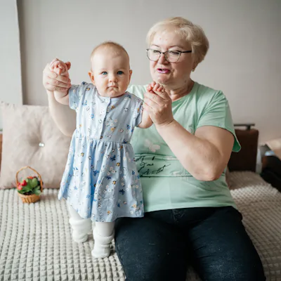 Grandmother lifts granddaughter in her arms