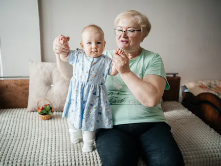 Grandmother lifts granddaughter in her arms