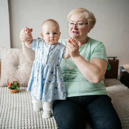 Grandmother lifts granddaughter in her arms