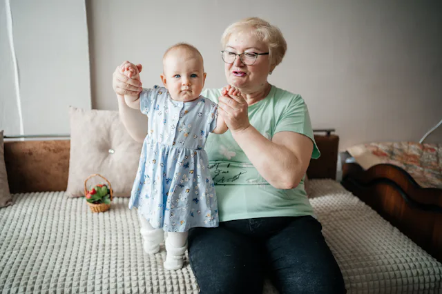 Grandmother lifts granddaughter in her arms