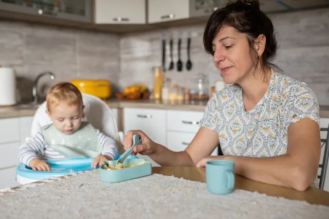 Morning scene of young beautiful mother and her son in the kitchen full of natural light. It's time ...