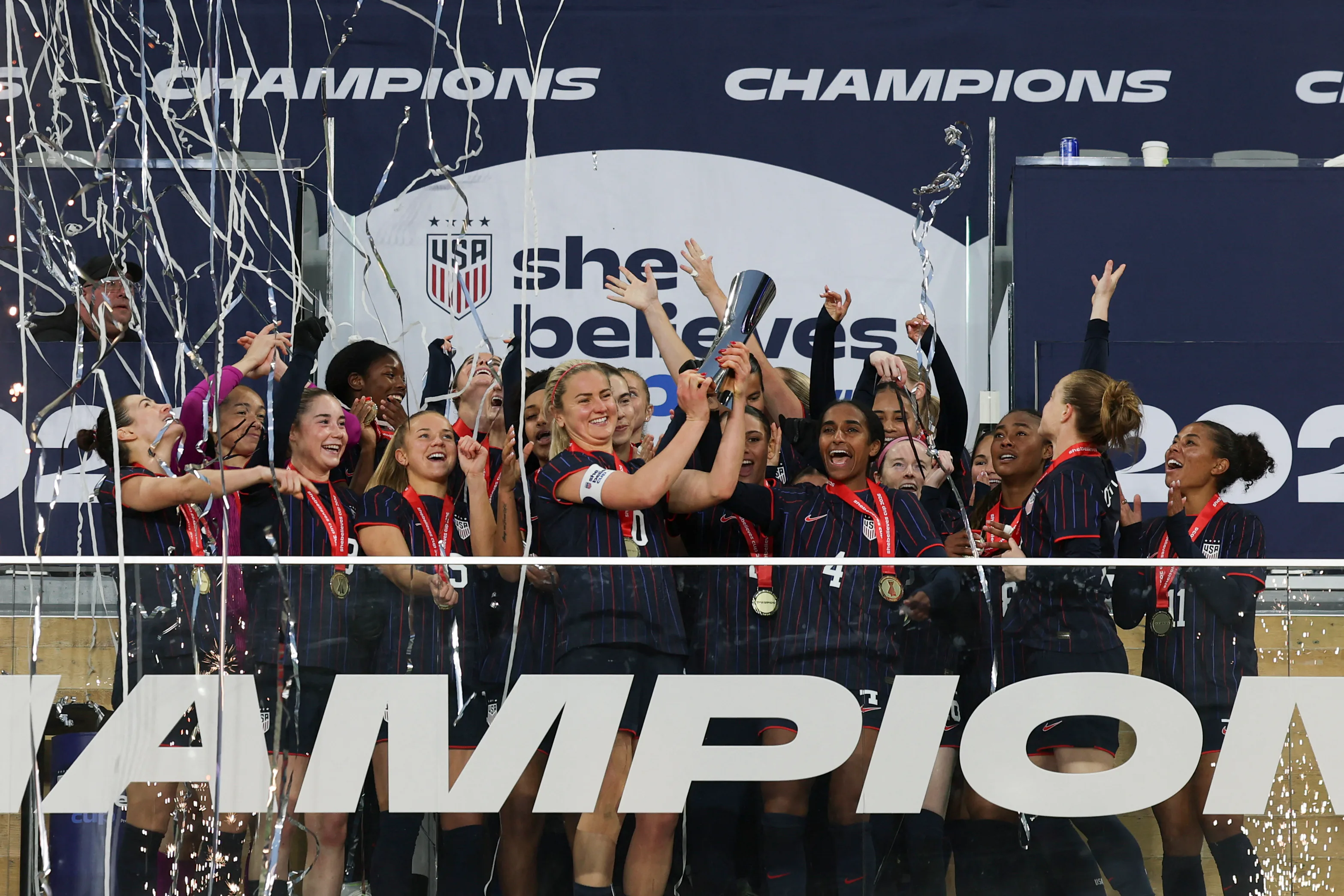 The USWNT hold up the SheBelieves Cup.